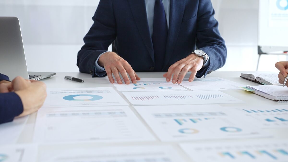 Executive working at desk reviewing reports