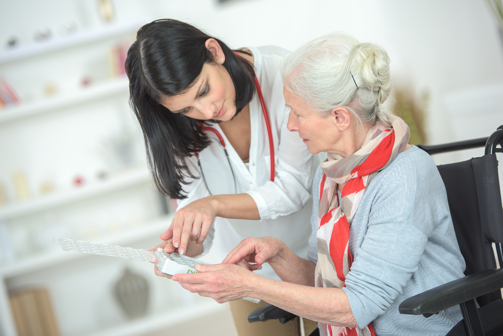 An APRN explaining a diagnosis to an elderly patient