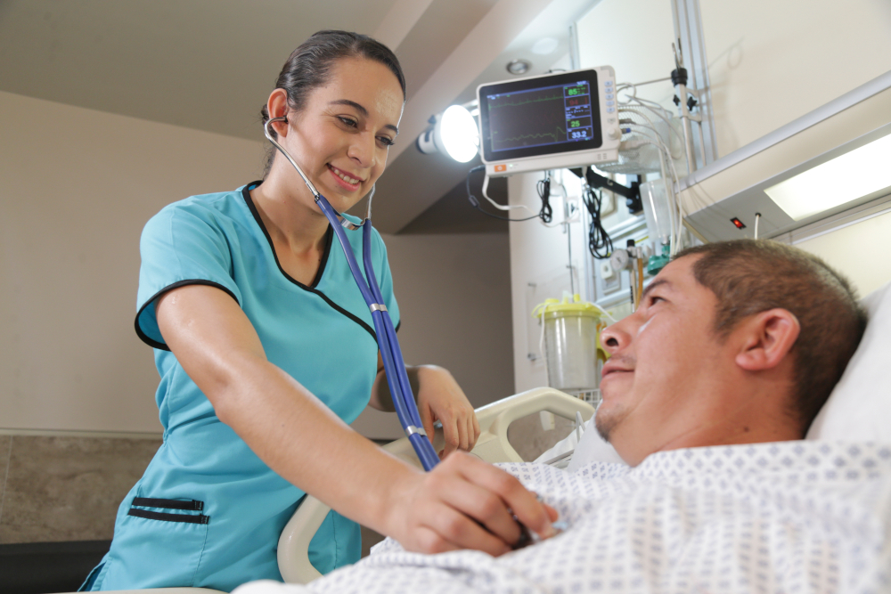 A nursing student working with a patient during her nursing rotations