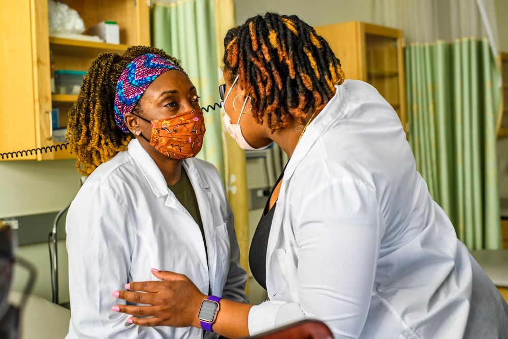 A Marymount nursing student doing an exercise on another student