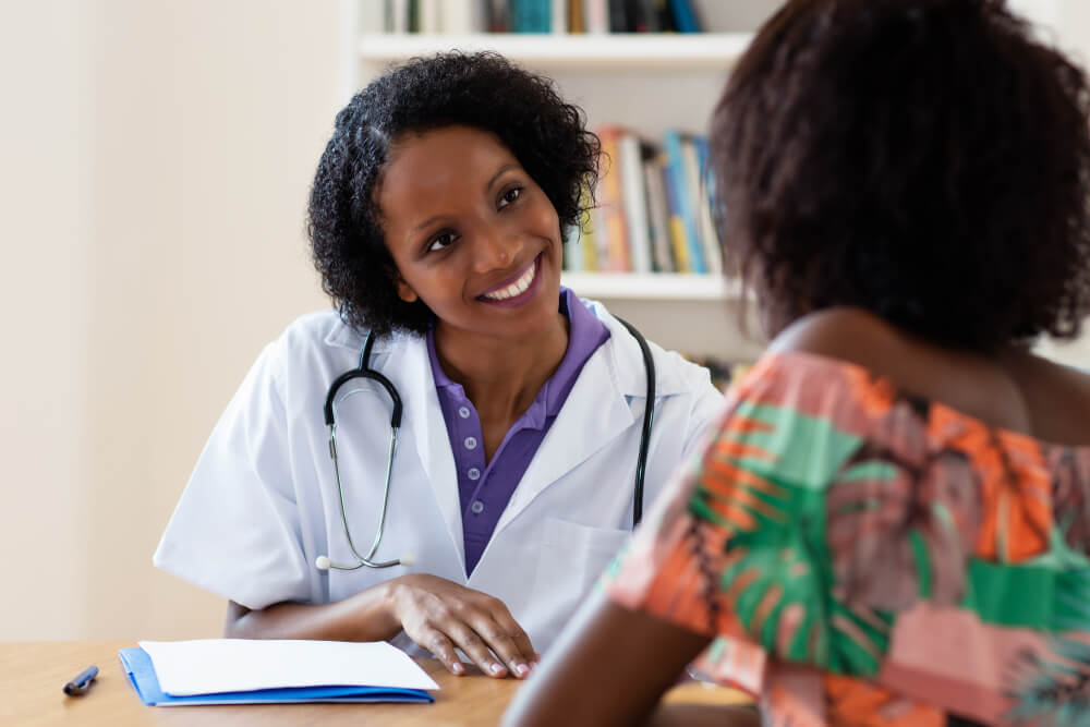 A nurse practitioner consulting with one of their patients