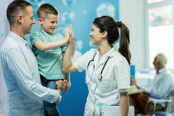 An FNP interacting with a young patient