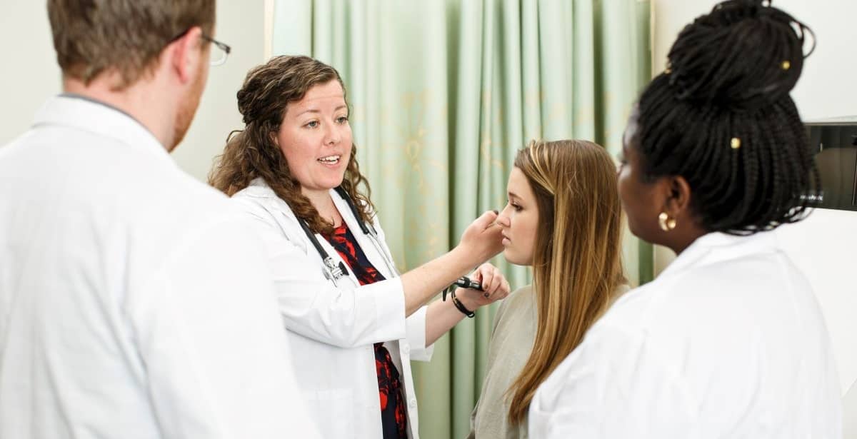 Family nurse practitioner students examining a patient