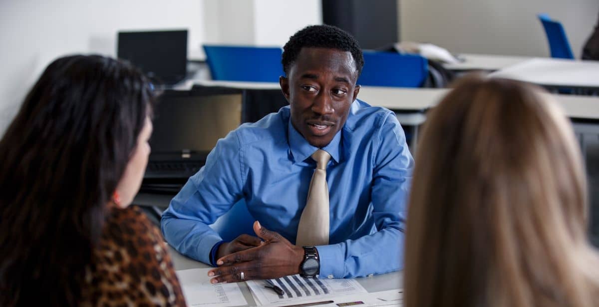 EdD professor talking to two of his graduate students