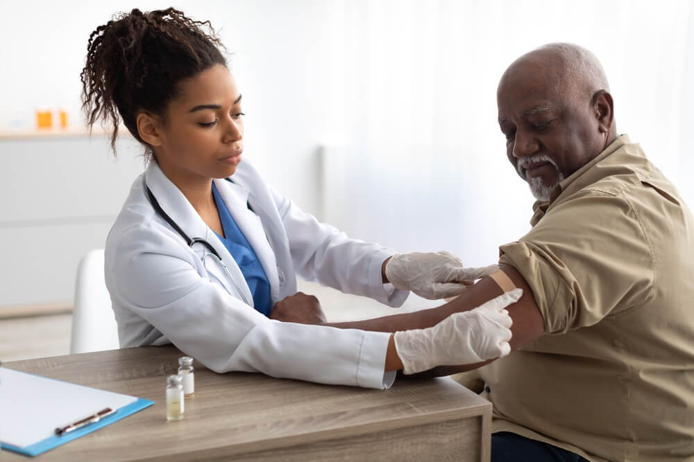 A nurse practitioner treating an older gentleman