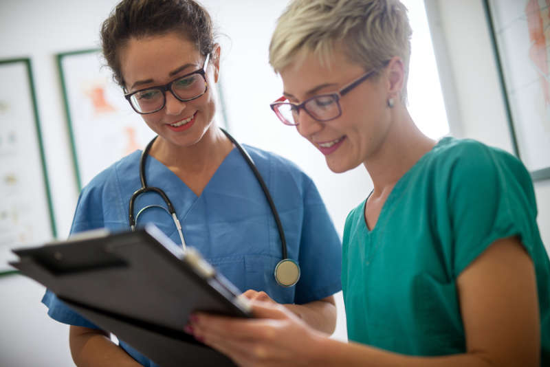 Two nurses looking at a chart