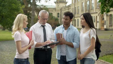 A university administrator showing off a campus to new students